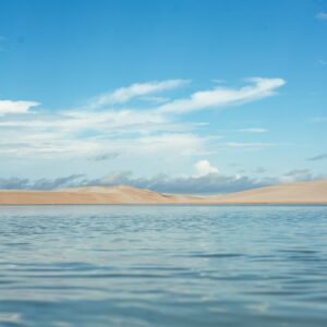Explore the tranquil beauty of MA, Brasil with clear lagoons, sandy dunes, and vibrant skies.