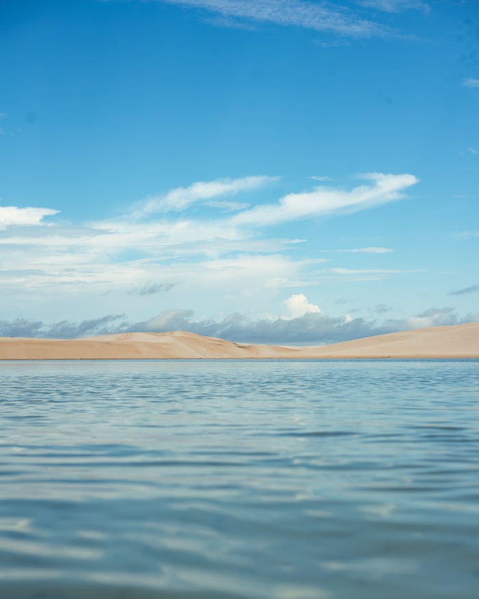 Explore the tranquil beauty of MA, Brasil with clear lagoons, sandy dunes, and vibrant skies.